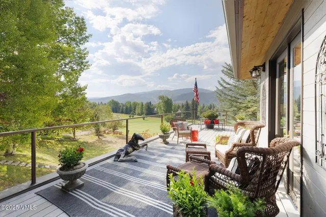 a view of a balcony with couch and wooden floor