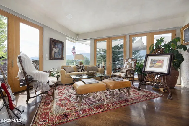 a living room with furniture large window and a table