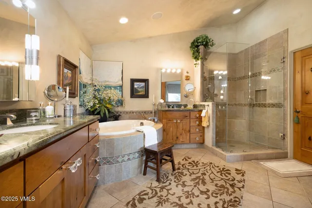 a bathroom with a granite countertop sink a toilet a mirror and shower