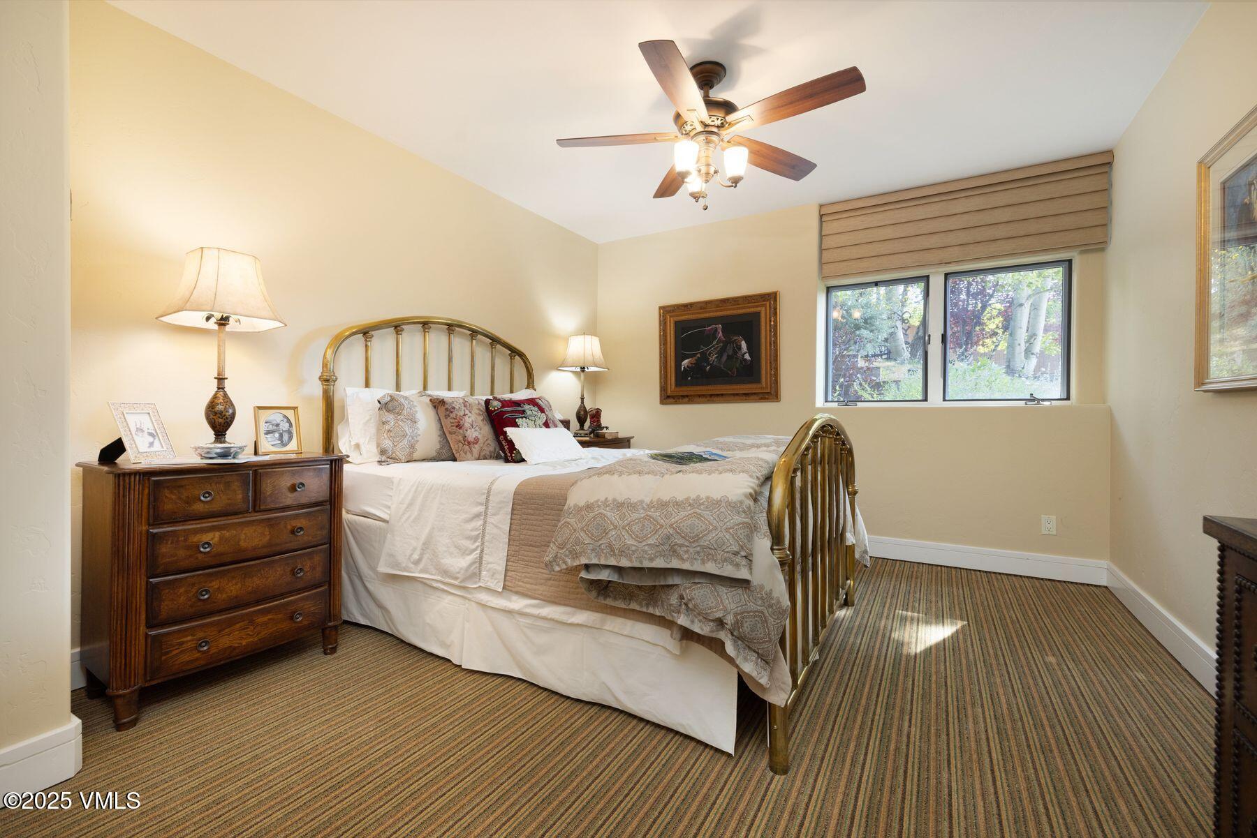470 Winslow Road Edwards, CO 81632 - Photo 22 of 33 a bed room with a bed and a chandelier
