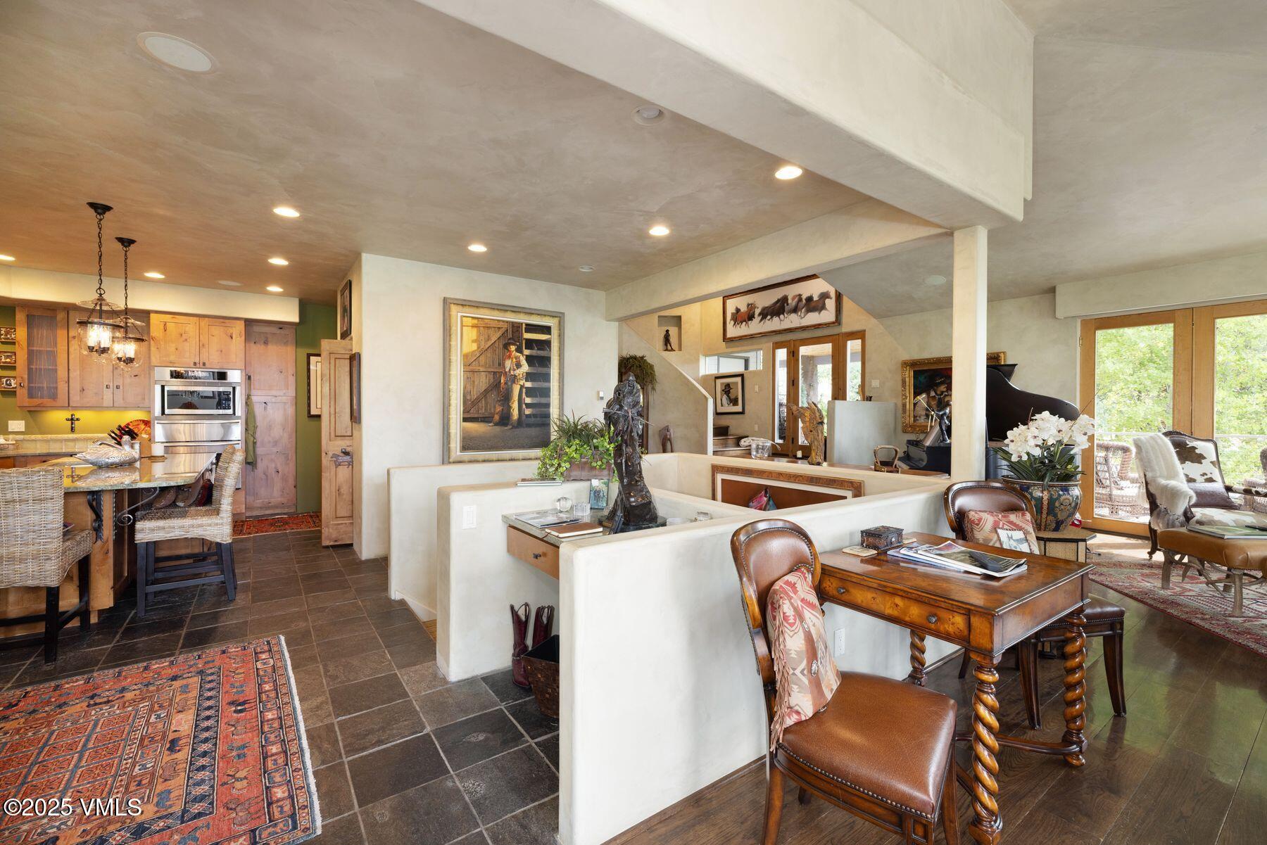 470 Winslow Road Edwards, CO 81632 - Photo 5 of 33 a living room with stainless steel appliances kitchen island granite countertop furniture a rug kitchen view and a fireplace