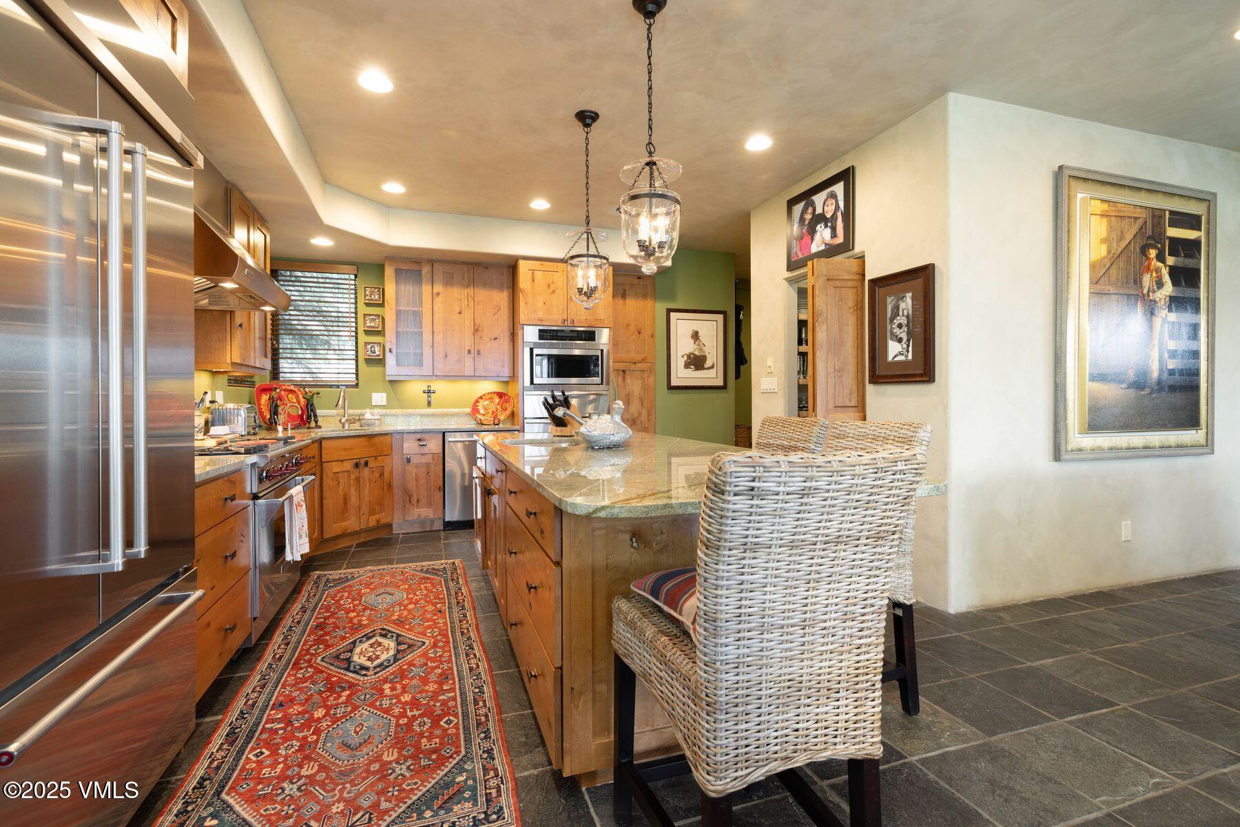 470 Winslow Road Edwards, CO 81632 - Photo 7 of 33 a dining hall with stainless steel appliances kitchen island granite countertop furniture and a rug