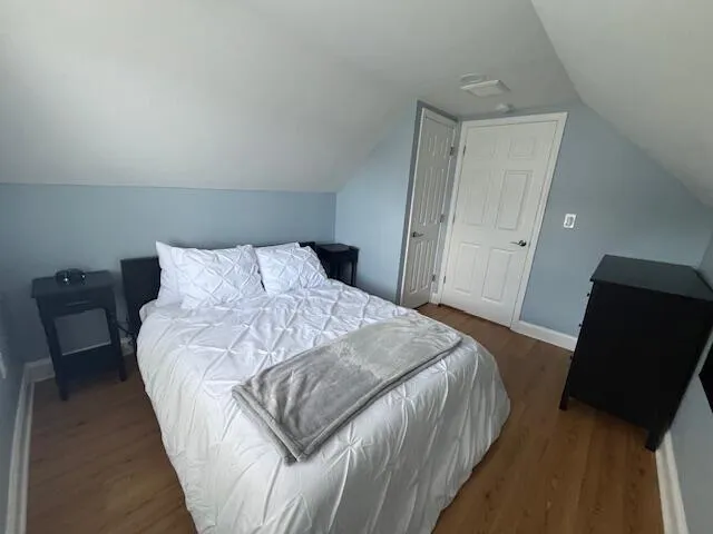 a bedroom with a bed and window