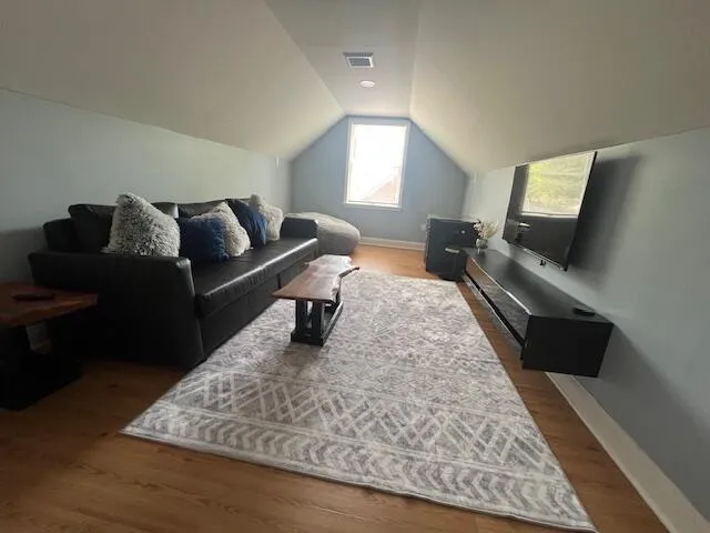 a living room with furniture and a rug