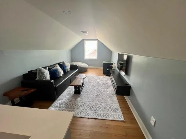 a bedroom with two beds and a flat screen tv