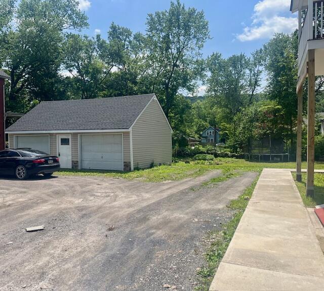 100 Broad Street, Unit E Stroudsburg, PA 18360 - Photo 24 of 25 a front view of a house with a yard and trees