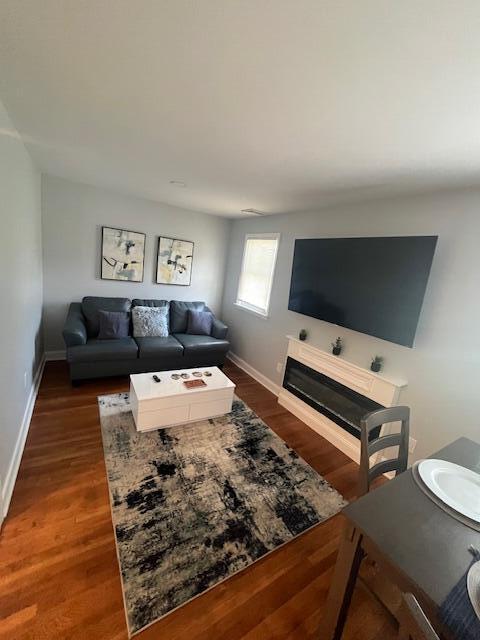 100 Broad Street, Unit E Stroudsburg, PA 18360 - Photo 6 of 25 a living room with furniture and a flat screen tv