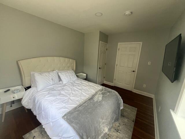 100 Broad Street, Unit E Stroudsburg, PA 18360 - Photo 9 of 25 a bedroom with a bed and a flat tv screen on the dresser