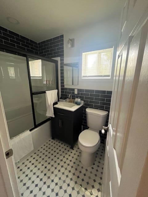 100 Broad Street, Unit E Stroudsburg, PA 18360 - Photo 10 of 25 a bathroom with a sink a toilet a mirror a vanity and window