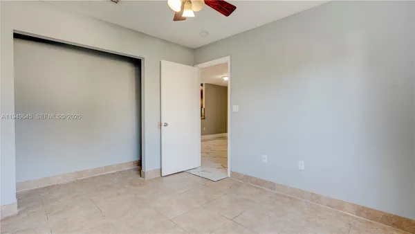 an empty room with a empty space and a ceiling fan