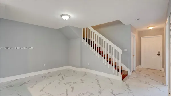 a view of a hallway with staircase