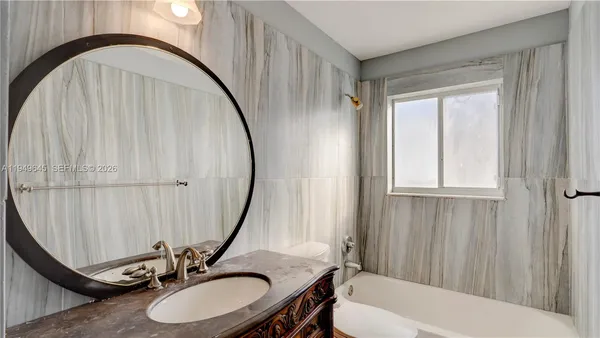 a bathroom with a double vanity sink a mirror and a toilet