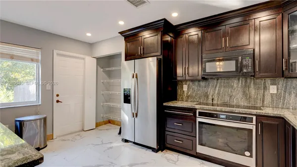 a kitchen with stove and cabinets