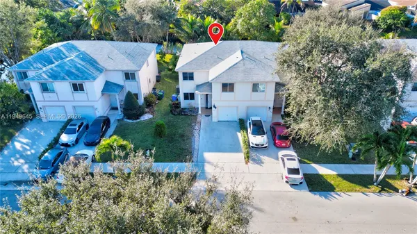 an aerial view of multiple houses with yard