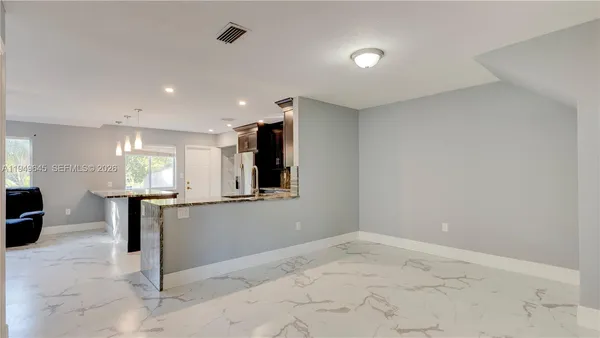 a view of kitchen with refrigerator and window