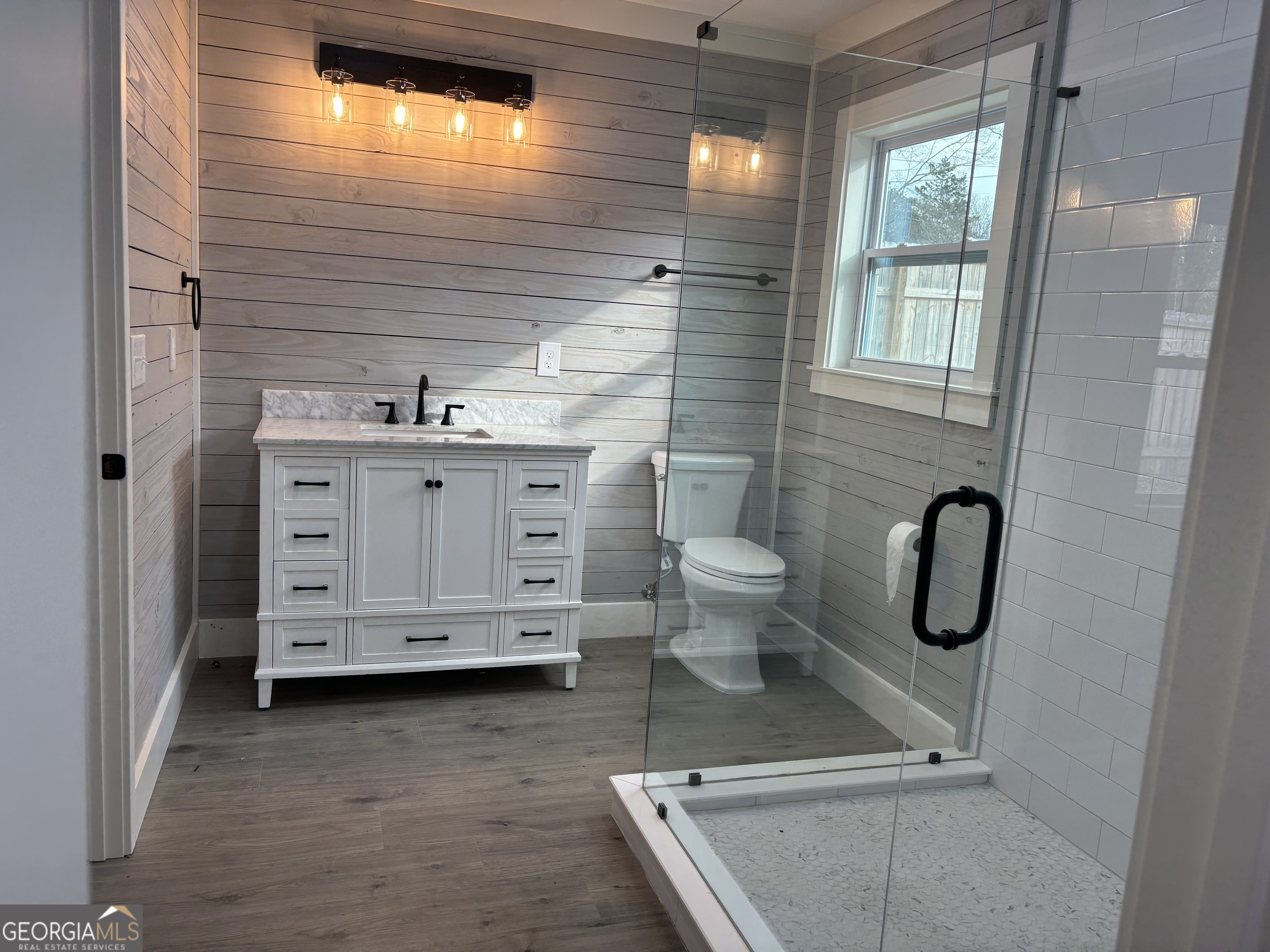 15 Alexander Street Rome, GA 30165 - Photo 13 of 19 a bathroom with a granite countertop toilet a sink a mirror and shower