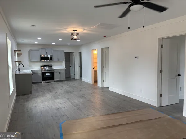 an open kitchen with refrigerator and cabinets