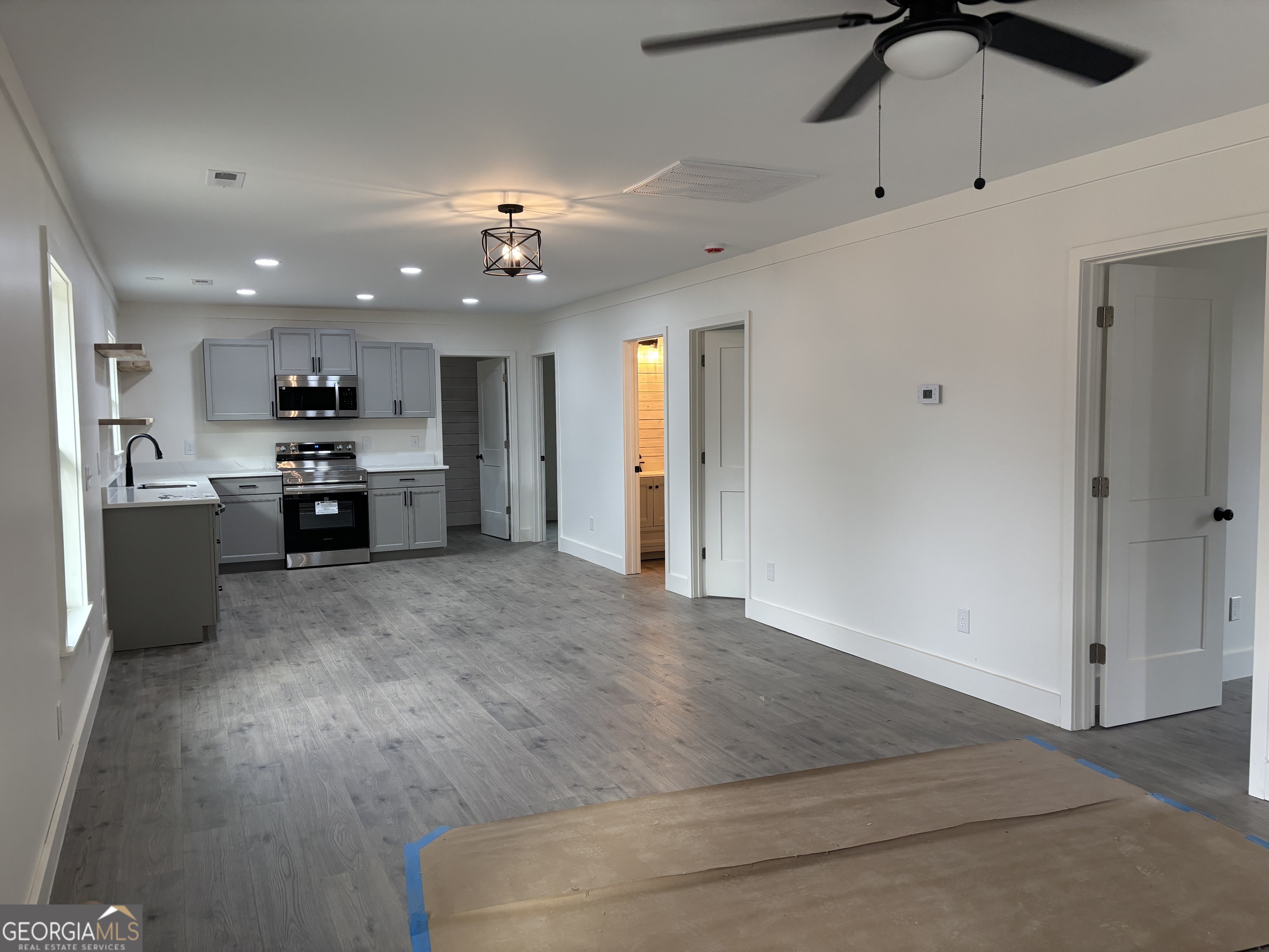 15 Alexander Street Rome, GA 30165 - Photo 2 of 19 an open kitchen with refrigerator and cabinets