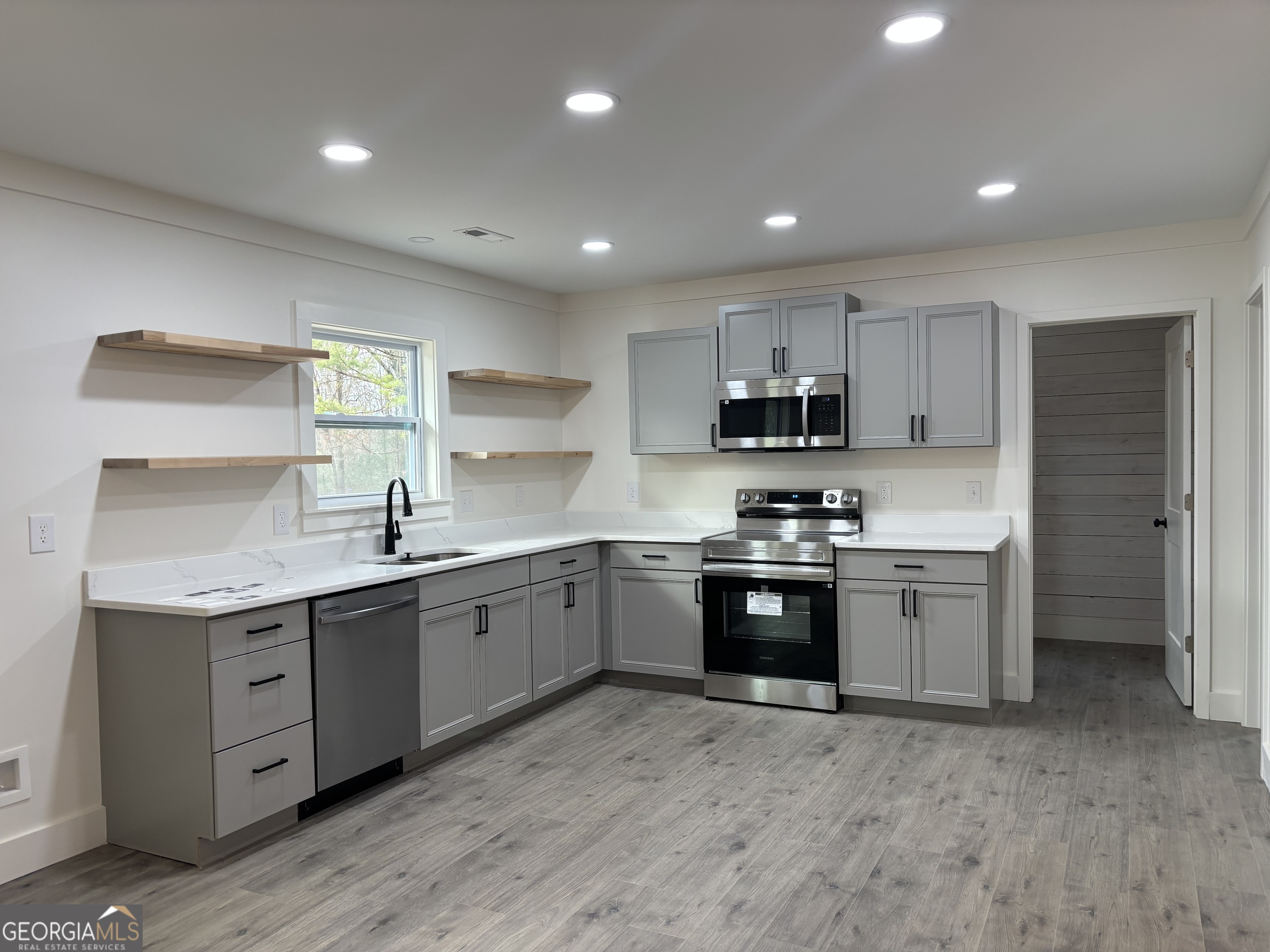 15 Alexander Street Rome, GA 30165 - Photo 3 of 19 a large kitchen with stainless steel appliances granite countertop a sink and cabinets