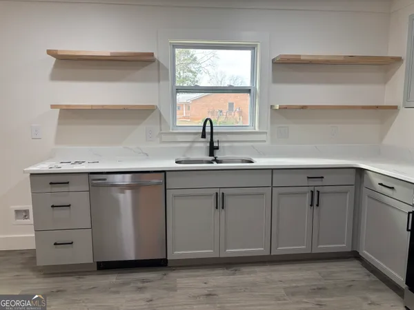 a kitchen with cabinets and window