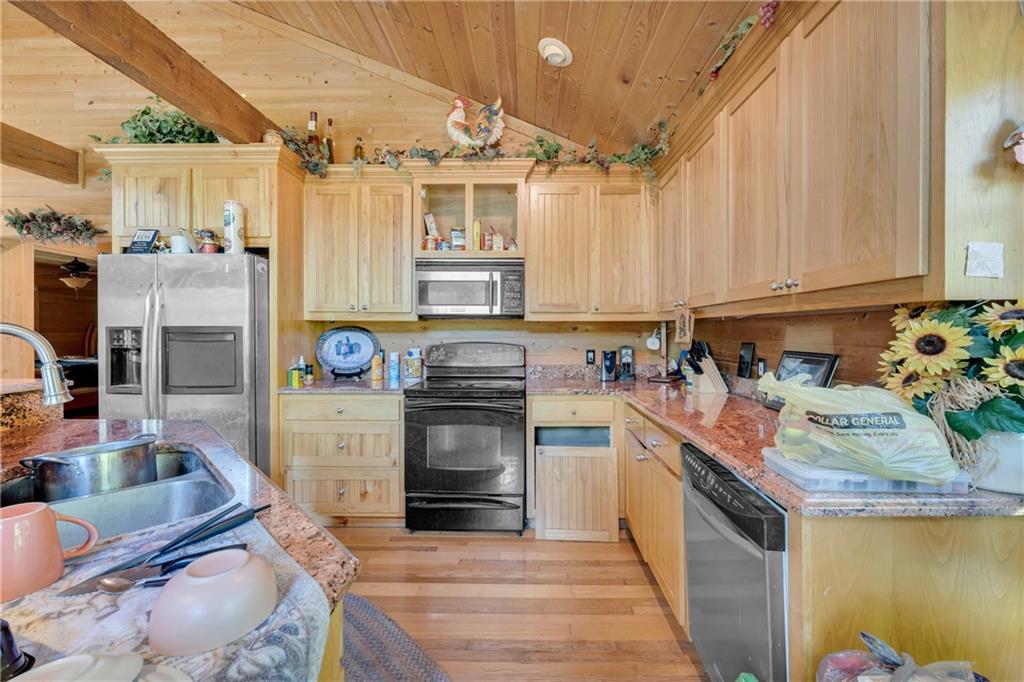 1641 Churchwell Rd Union Point Union Point, GA 30669 - Photo 22 of 45 a kitchen with stainless steel appliances granite countertop a stove a sink and a microwave
