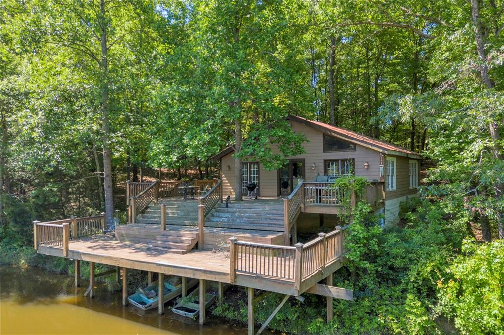 1641 Churchwell Rd Union Point Union Point, GA 30669 - Photo 5 of 45 a view of house with yard outdoor seating and lake