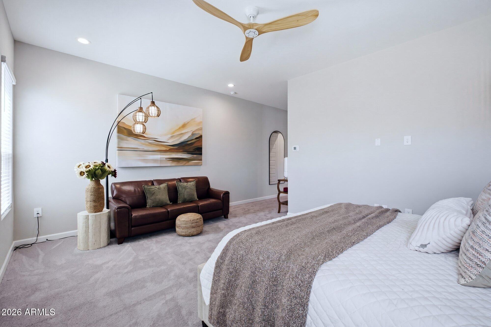 5963 East Lone Cactus Road Phoenix, AZ 85054 - Photo 16 of 22 a bedroom with a bed and chandelier