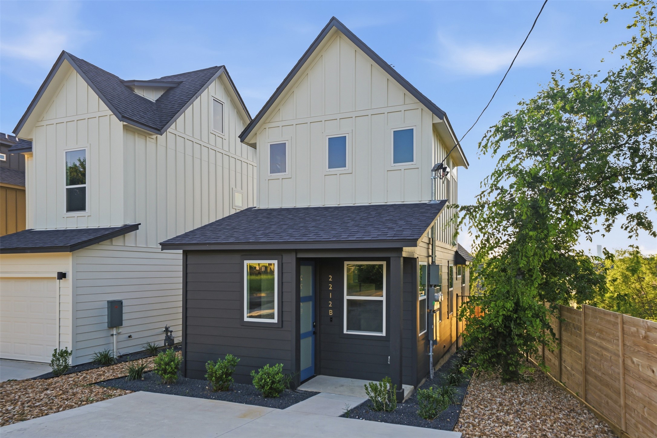 2212 Yellow Jacket Lane, Unit 2 Austin, TX 78741 - Photo 3 of 25 Contemporary two-story residence featuring a dark gray lower level and light-toned board and batten siding
