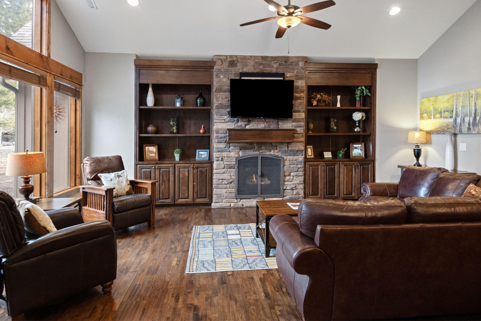 56508 Dancing Rock Loop, Unit 22 Bend, OR 97707 - Photo 13 of 69 a living room with fireplace furniture and a flat screen tv