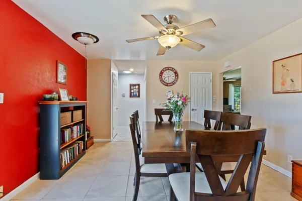 a view of a dining room with furniture and a chandelier