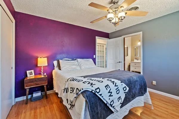 a bedroom with a large bed and a chandelier