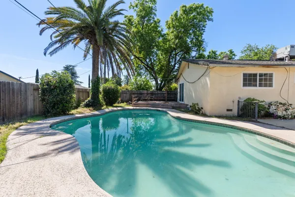 a view of a swimming pool with a patio