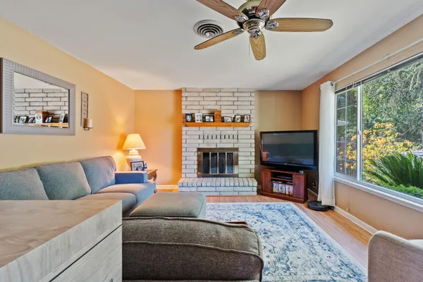 a living room with furniture a fireplace and a flat screen tv