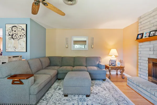 a living room with furniture and a fireplace