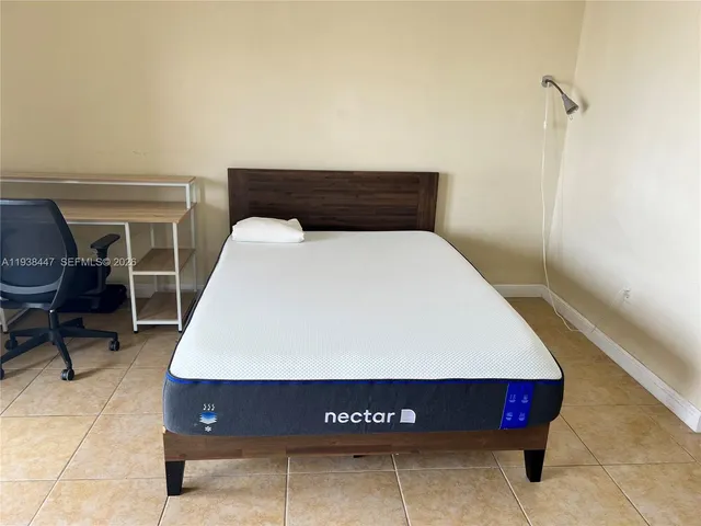 a bed sitting in a bedroom and chair