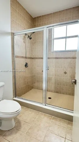 a bathroom with a shower and a toilet
