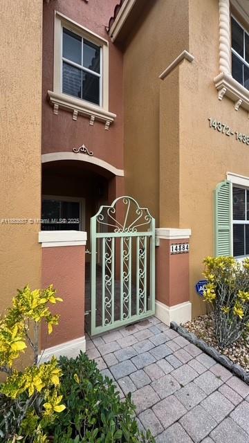 14384 Southwest 11th Street, Unit 904 Pembroke Pines, FL 33027 - Photo 2 of 22 a front view of a house with a yard