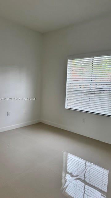 14384 Southwest 11th Street, Unit 904 Pembroke Pines, FL 33027 - Photo 4 of 22 an empty room with a window