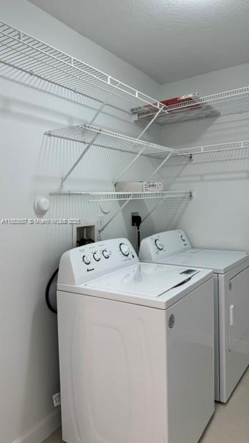 14384 Southwest 11th Street, Unit 904 Pembroke Pines, FL 33027 - Photo 8 of 22 a utility room with dryer and washer