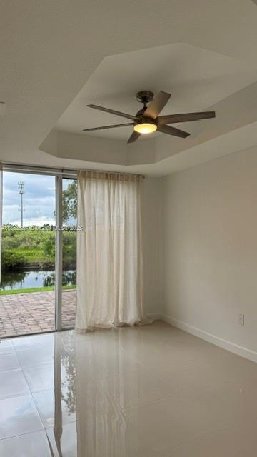 14384 Southwest 11th Street, Unit 904 Pembroke Pines, FL 33027 - Photo 10 of 22 an empty room with a ceiling fan and windows