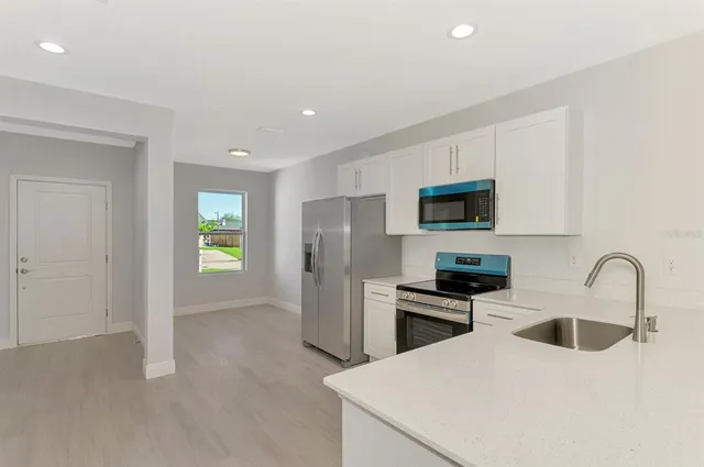 a view of a kitchen with a sink and a window