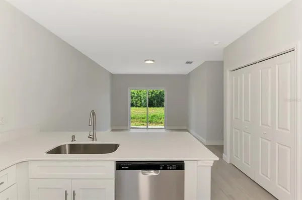 an empty room with a ceiling fan and a window