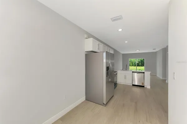 a bathroom with a toilet a sink a mirror a bathtub and vanity