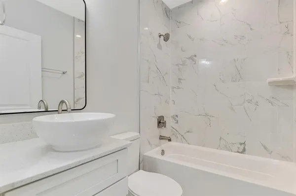 a kitchen with kitchen island a sink stainless steel appliances and window