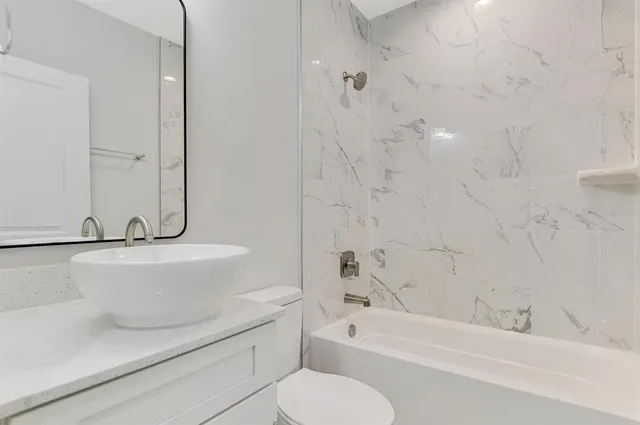 a kitchen with kitchen island a sink stainless steel appliances and window
