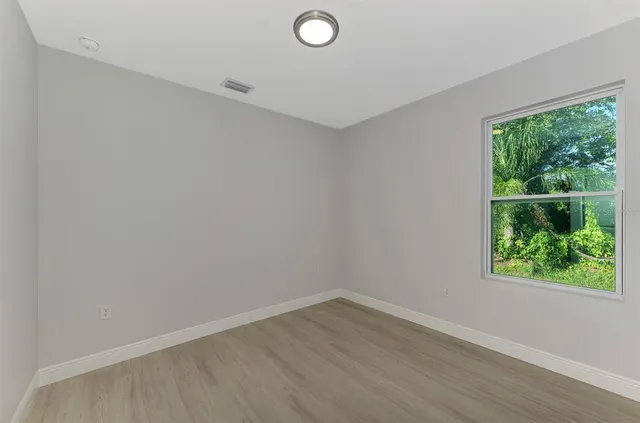a kitchen with stainless steel appliances a sink a microwave a refrigerator and cabinets