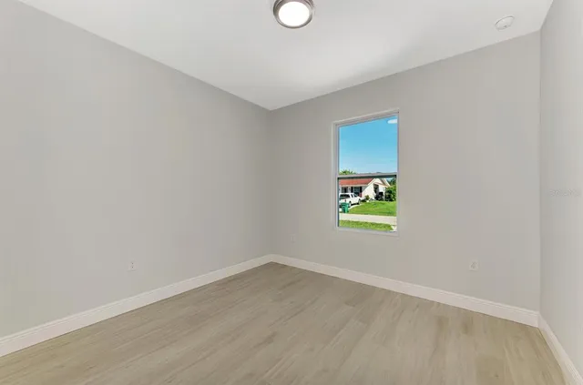 a kitchen with a refrigerator and a stove top oven