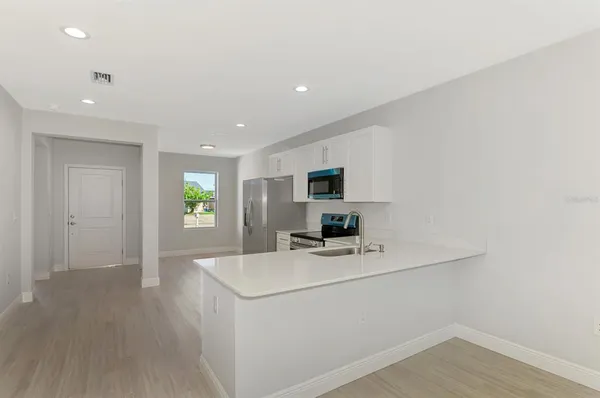 an empty room with a window and wooden floor