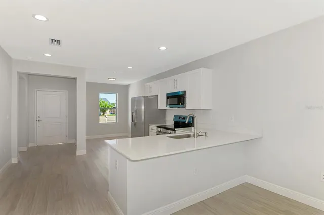 an empty room with a window and wooden floor