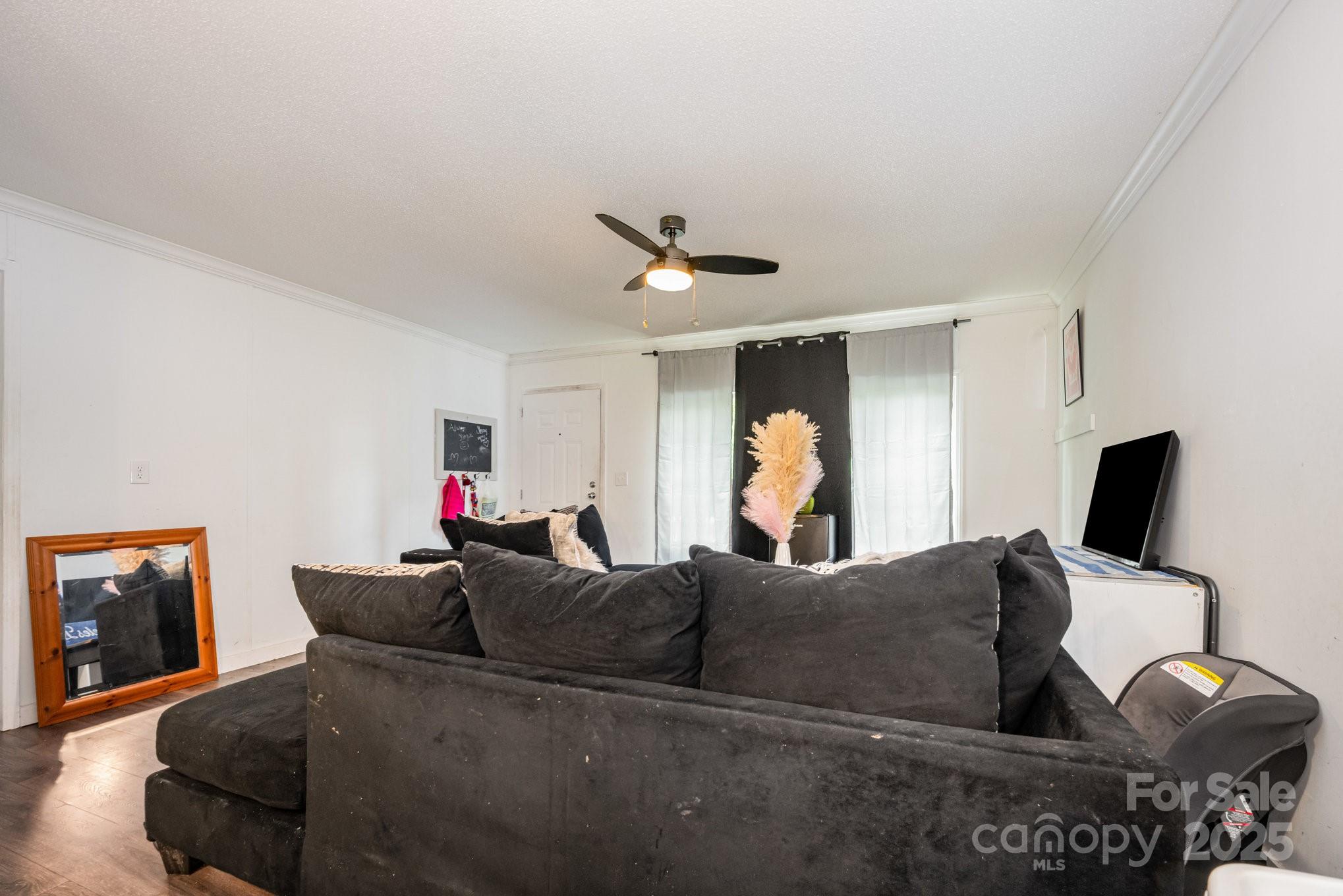 6555 McIntosh Road Stanley, NC 28164 - Photo 4 of 24 a living room with furniture and a flat screen tv
